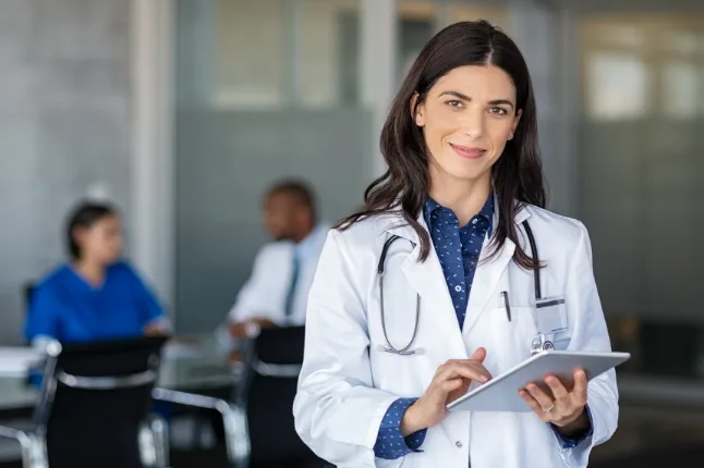 Healthcare professional reviewing an online course on a tablet